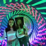 dwie osoby w tunelu światła i kolorów