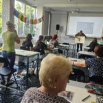 sala warsztatowa i uczestnicy przy stołach
