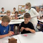 bibliotekarka rozdaje dzieciom cukierki